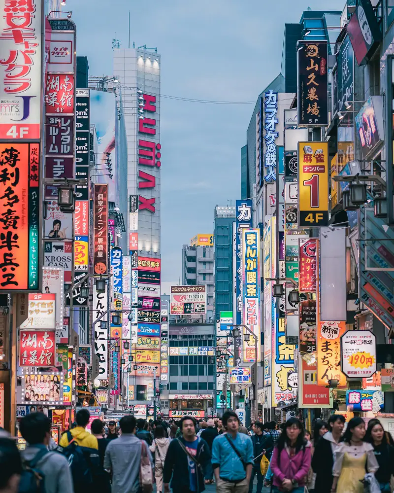 Rue commerçante de Tokyo bordée d’enseignes lumineuses, voyage au Japon en famille